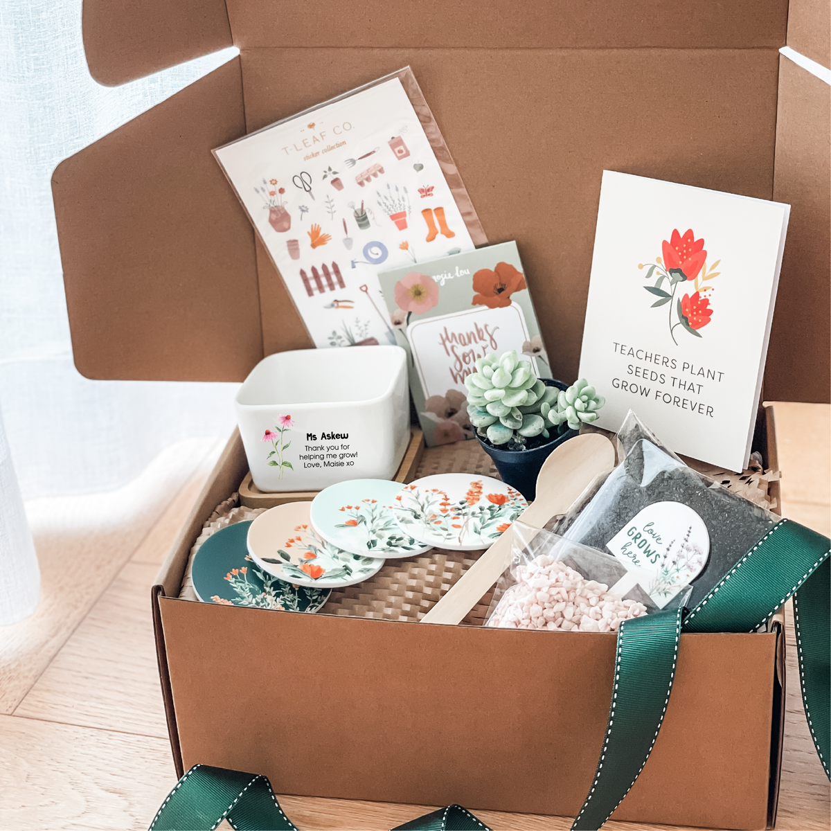 Gift box with stationery items including cards, a ceramic planter pot, a succulent and a set of 4 fridge magnets.